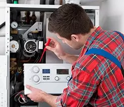 engineer repairing a boiler
